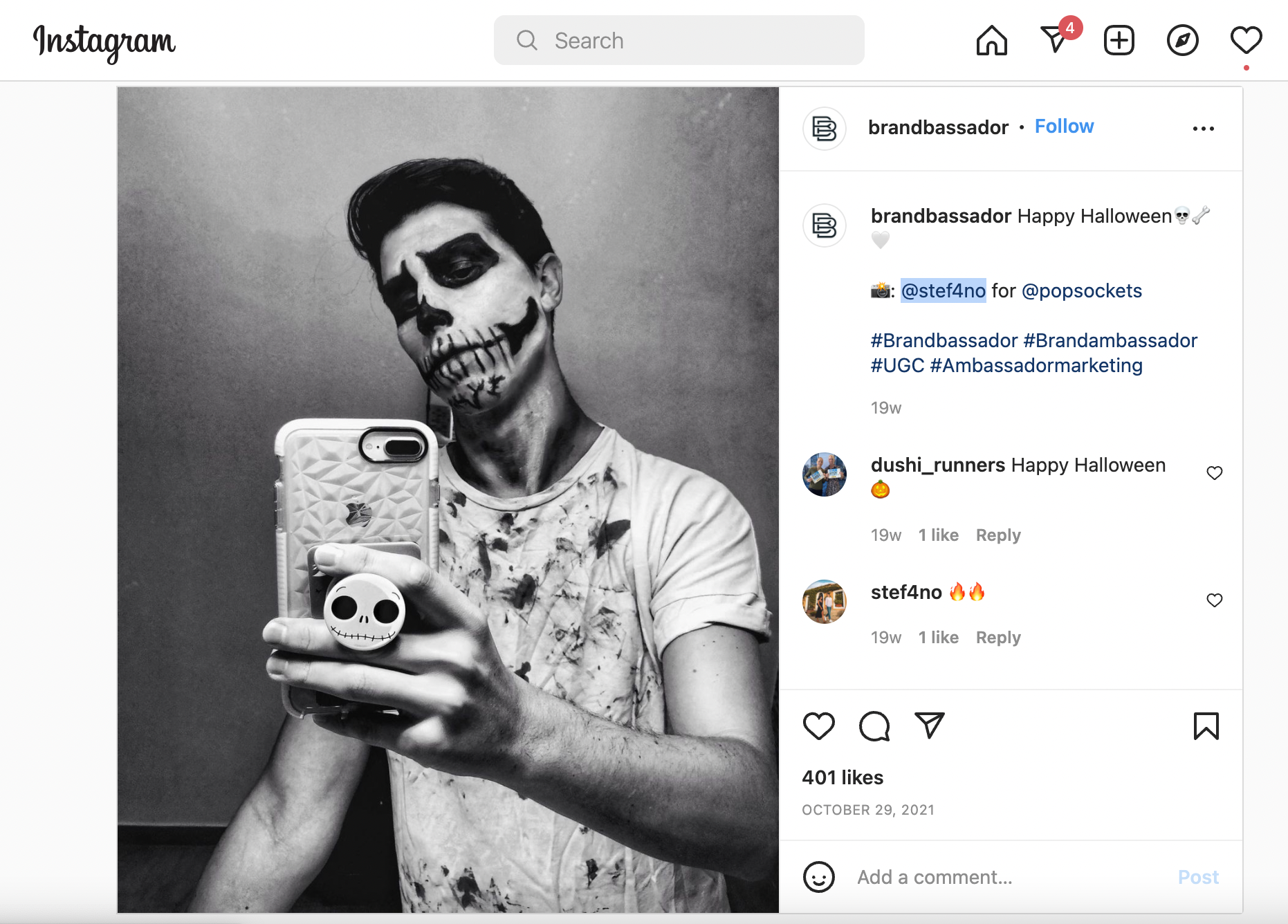 A screenshot Popsockets’ Emoji Outfit Challenge Instagram post. The image features a man with Halloween skull makeup, holding a phone with a skull Popsockets design, corresponding to the skull emoji.